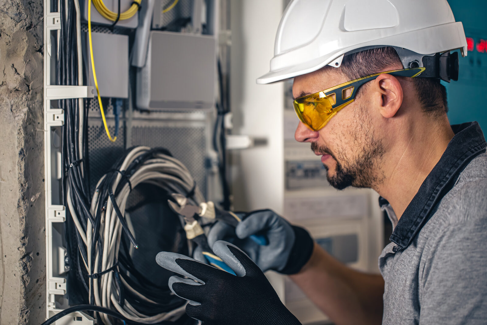 Industrial electrician working on a wiring panel